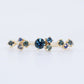 A cluster of blue green sapphires on a thin gold ring band, made by Vazana. 